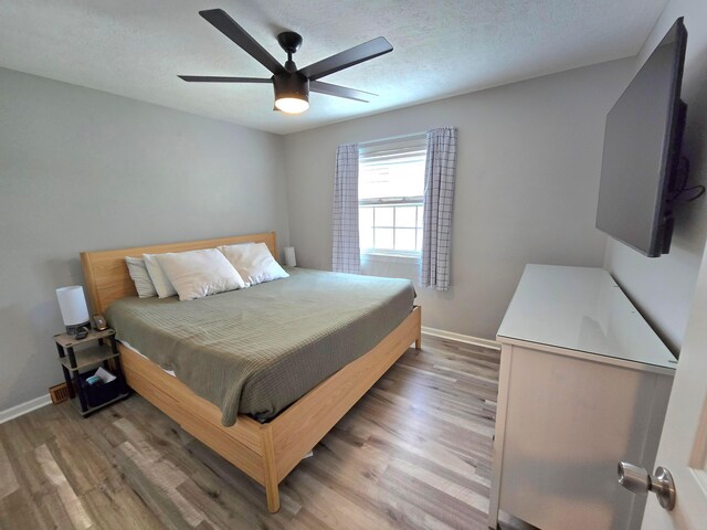 3523 Meldrake St, Columbus, OH 43230 - bedroom with light wood finished floors, baseboards, a ceiling fan, and a textured ceiling