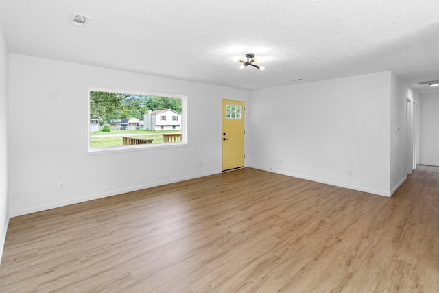 70 5th Ave SW, Etna, OH 43062 - empty room featuring light wood-type flooring, baseboards, and a chandelier