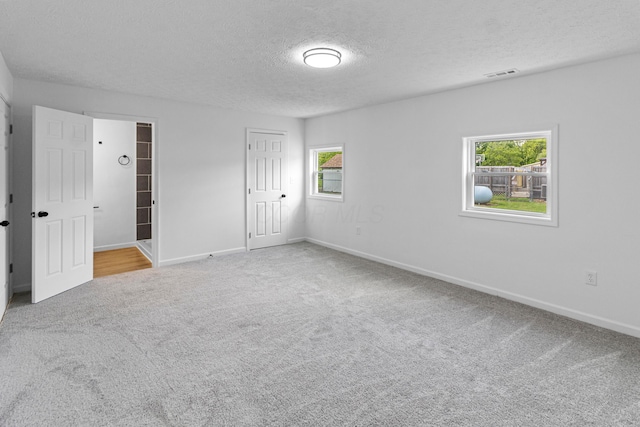 70 5th Ave SW, Etna, OH 43062 - unfurnished bedroom with carpet, a textured ceiling, baseboards, and a closet