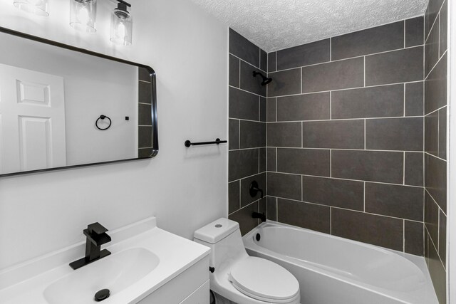 70 5th Ave SW, Etna, OH 43062 - bathroom featuring a textured ceiling, toilet, vanity, and bathtub / shower combination