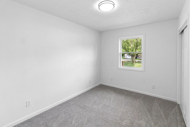 70 5th Ave SW, Etna, OH 43062 - unfurnished room featuring a textured ceiling, carpet flooring, and baseboards