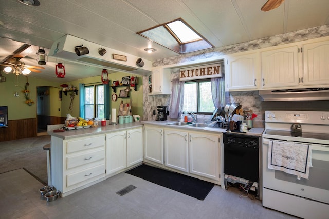 7326 State Route 19 Unit 5, Lot 105-107, Mount Gilead, OH 43338 - kitchen featuring white electric range oven, under cabinet range hood, a peninsula, wainscoting, and a sink