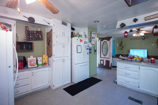 7326 State Route 19 Unit 5, Lot 105-107, Mount Gilead, OH 43338 - kitchen with white fridge with ice dispenser, freestanding refrigerator, ceiling fan, white cabinetry, and tile patterned floors