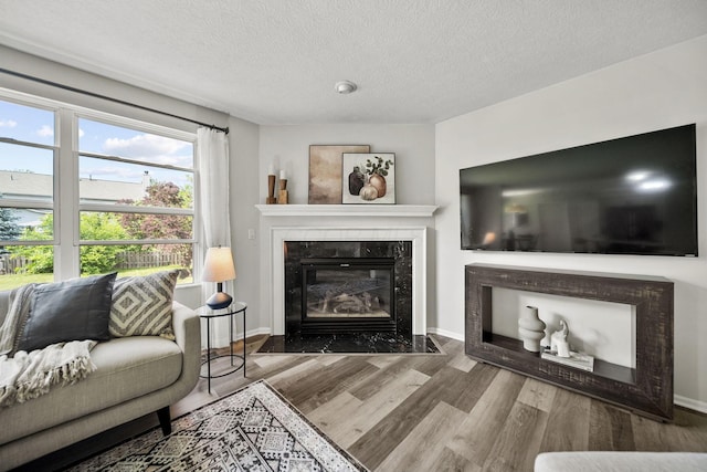 1779 Westwood Dr, Lewis Center, OH 43035 - living area featuring a fireplace, wood finished floors, a textured ceiling, and baseboards