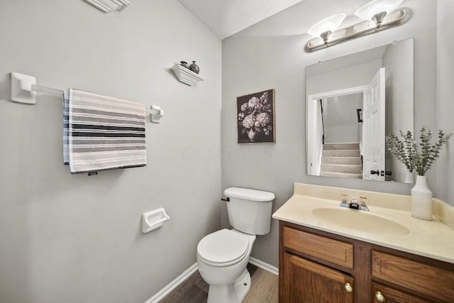 1779 Westwood Dr, Lewis Center, OH 43035 - bathroom featuring toilet, vanity, baseboards, and wood finished floors