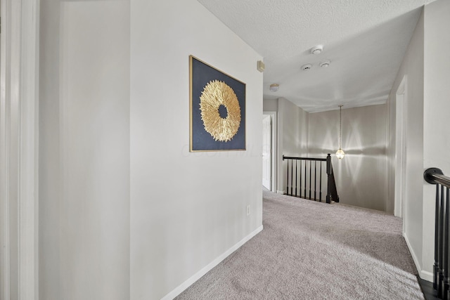 1779 Westwood Dr, Lewis Center, OH 43035 - hall with an upstairs landing, carpet floors, a textured ceiling, and baseboards