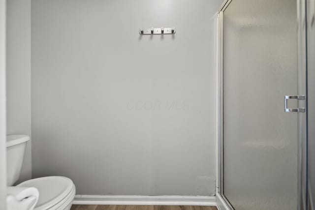 1779 Westwood Dr, Lewis Center, OH 43035 - full bathroom with wood finished floors, a stall shower, and toilet
