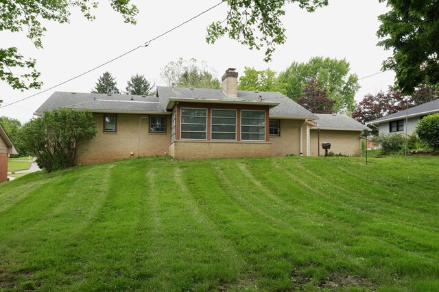 1602 Pleasantview Dr, Lancaster, OH 43130 - back of property featuring brick siding, a lawn, and a chimney
