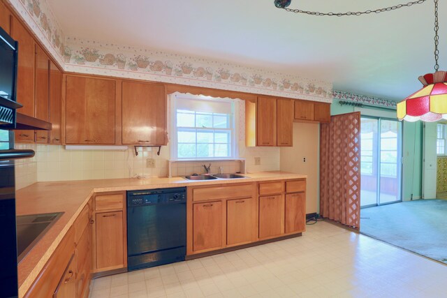 1602 Pleasantview Dr, Lancaster, OH 43130 - kitchen with black appliances, a sink, light countertops, decorative backsplash, and brown cabinetry