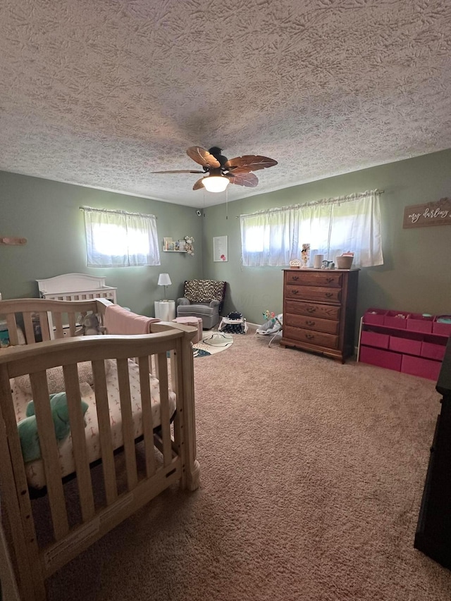 4902 Columbus Sandusky Rd N, Marion, OH 43302 - carpeted bedroom featuring a textured ceiling, a ceiling fan, and a crib