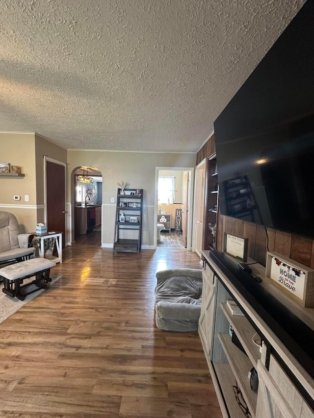 4902 Columbus Sandusky Rd N, Marion, OH 43302 - living area featuring a textured ceiling, dark wood-style flooring, and arched walkways