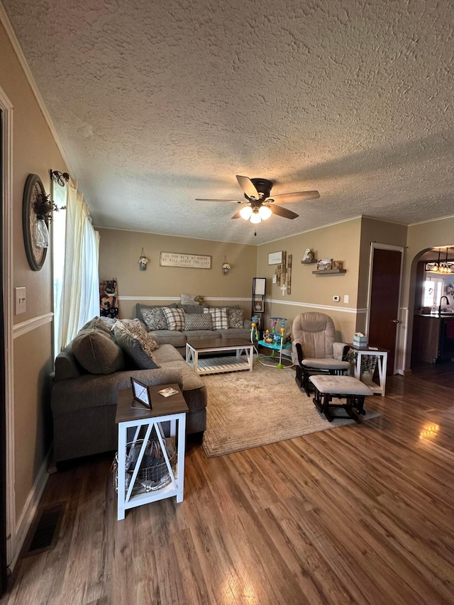 4902 Columbus Sandusky Rd N, Marion, OH 43302 - living room with arched walkways, ceiling fan, wood finished floors, and a textured ceiling