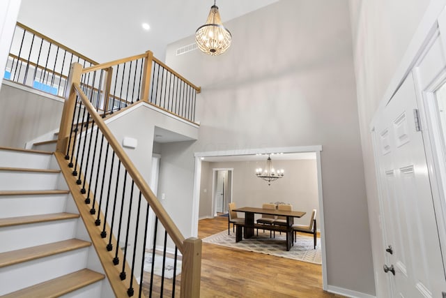 3000 State Route 257, Radnor, OH 43066 - stairway featuring a chandelier, a high ceiling, wood finished floors, and baseboards