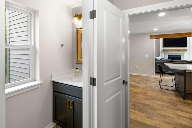 3000 State Route 257, Radnor, OH 43066 - bathroom with a fireplace, vanity, wood finished floors, baseboards, and recessed lighting