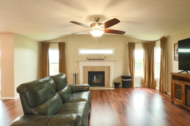 1690 Autumn Dr, Lancaster, OH 43130 - living area with lofted ceiling, ceiling fan, a tile fireplace, dark wood-type flooring, and a textured ceiling