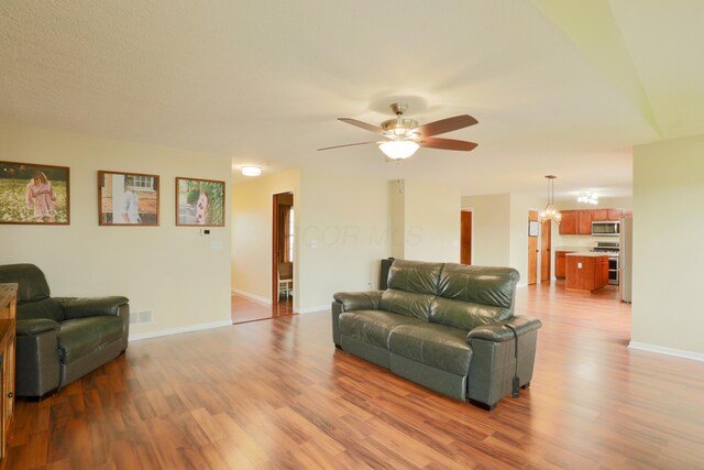 1690 Autumn Dr, Lancaster, OH 43130 - living area with wood finished floors, a ceiling fan, and baseboards