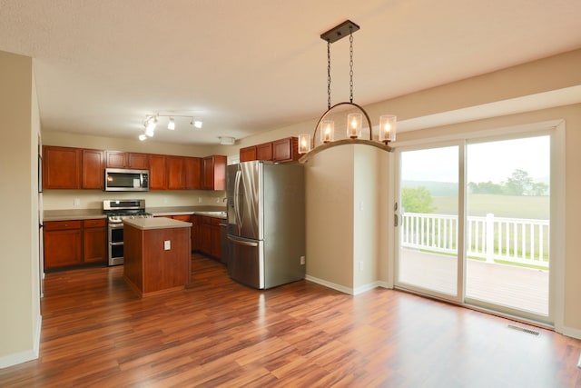 1690 Autumn Dr, Lancaster, OH 43130 - kitchen with stainless steel appliances, light countertops, dark wood-style floors, and brown cabinetry