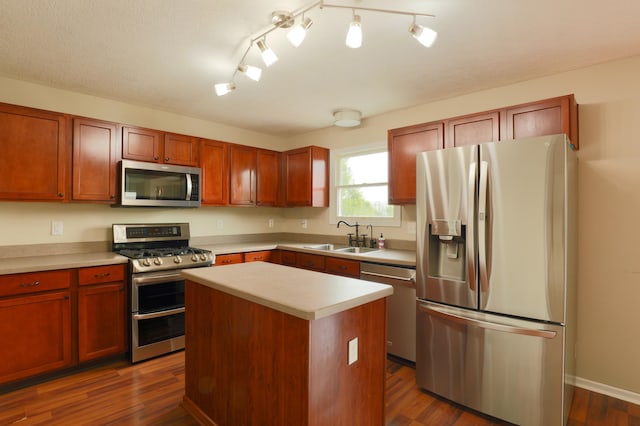 1690 Autumn Dr, Lancaster, OH 43130 - kitchen featuring appliances with stainless steel finishes, a sink, light countertops, a center island, and dark wood-type flooring