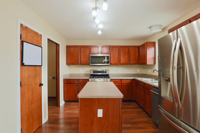1690 Autumn Dr, Lancaster, OH 43130 - kitchen featuring stainless steel appliances, dark wood-style flooring, light countertops, a sink, and a center island