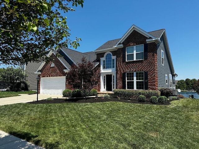 1279 Forsyth Ln, Galena, OH 43021 - view of front facade with a front lawn, concrete driveway, a garage, and brick siding
