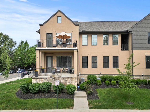 233 S Ohio Ave Unit 11, Columbus, OH 43205 - townhome / multi-family property with a balcony, stucco siding, and a front yard