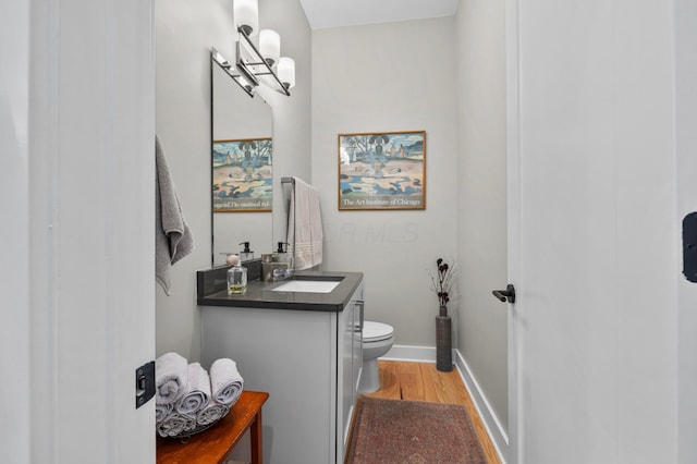 233 S Ohio Ave Unit 11, Columbus, OH 43205 - half bath featuring toilet, wood finished floors, vanity, and baseboards