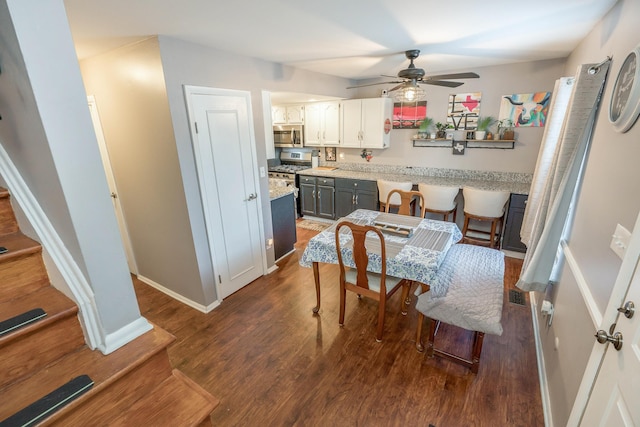 2560 Scioto View Ln, Columbus, OH 43221 - dining room featuring ceiling fan, dark wood-style floors, baseboards, and stairway