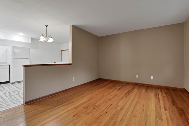 6451 Faircrest Rd, Columbus, OH 43229 - unfurnished room with light wood-style floors, baseboards, and a chandelier