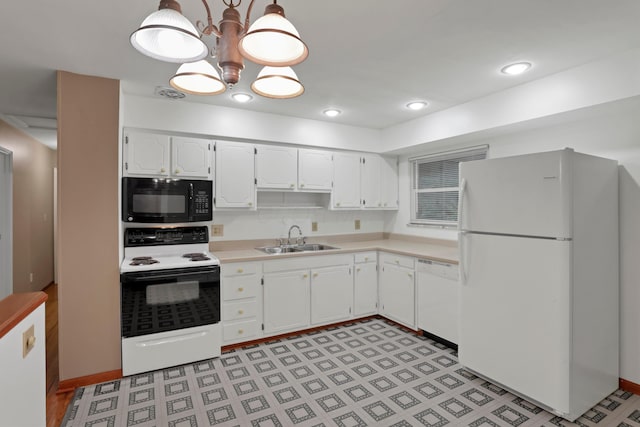 6451 Faircrest Rd, Columbus, OH 43229 - kitchen with white appliances, a sink, white cabinets, and light countertops
