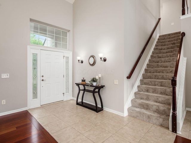 7915 Fargo Ln, Delaware, OH 43015 - entryway featuring a high ceiling, stairs, baseboards, and light tile patterned floors