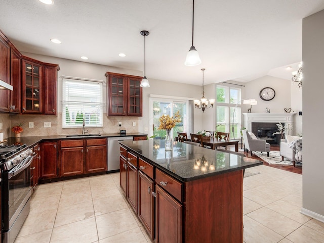 7915 Fargo Ln, Delaware, OH 43015 - kitchen with stainless steel appliances, a sink, backsplash, light tile patterned flooring, and a kitchen island