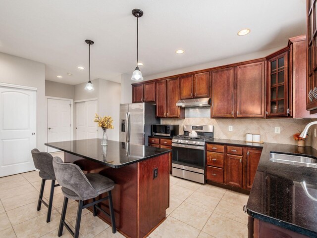 7915 Fargo Ln, Delaware, OH 43015 - kitchen featuring appliances with stainless steel finishes, under cabinet range hood, a sink, light tile patterned floors, and recessed lighting