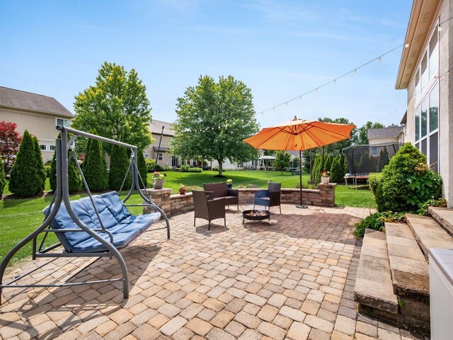 7915 Fargo Ln, Delaware, OH 43015 - view of patio / terrace with a trampoline, an outdoor fire pit, and a playground