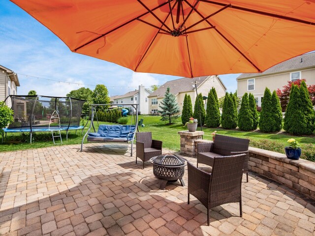 7915 Fargo Ln, Delaware, OH 43015 - view of patio / terrace featuring a trampoline and an outdoor living space with a fire pit