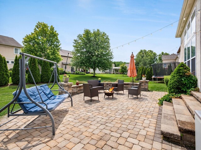 7915 Fargo Ln, Delaware, OH 43015 - view of patio with a trampoline and a fire pit