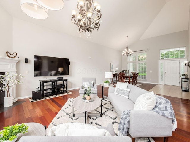 7915 Fargo Ln, Delaware, OH 43015 - living area featuring a chandelier, high vaulted ceiling, wood finished floors, and baseboards