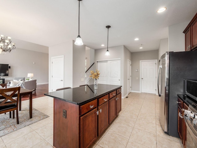 7915 Fargo Ln, Delaware, OH 43015 - kitchen with light tile patterned flooring, recessed lighting, a center island, hanging light fixtures, and freestanding refrigerator
