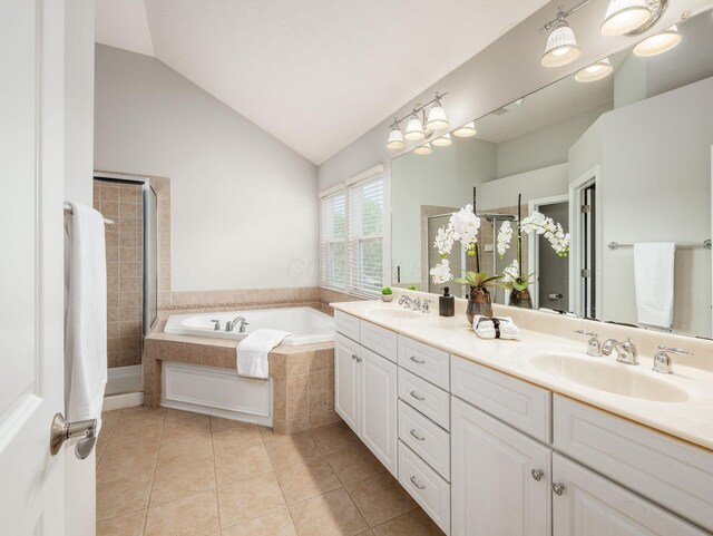 7915 Fargo Ln, Delaware, OH 43015 - full bathroom with a bath, double vanity, tile patterned floors, vaulted ceiling, and a shower stall