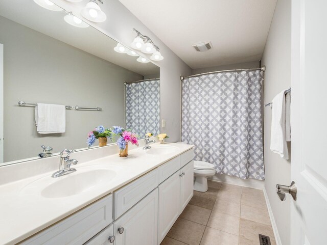 7915 Fargo Ln, Delaware, OH 43015 - full bathroom with double vanity, toilet, tile patterned flooring, and a shower with curtain