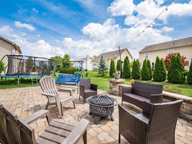 7915 Fargo Ln, Delaware, OH 43015 - view of patio featuring a trampoline, an outdoor living space with a fire pit, and a residential view