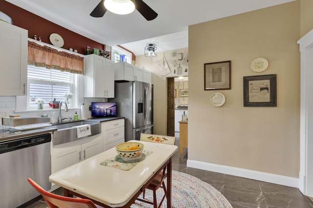 1350 Lancaster Kirkersville Rd NW, Lancaster, OH 43130 - kitchen with appliances with stainless steel finishes, a sink, a ceiling fan, white cabinetry, and baseboards