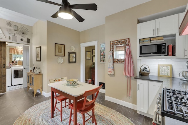 1350 Lancaster Kirkersville Rd NW, Lancaster, OH 43130 - dining area featuring washer / clothes dryer, ceiling fan, baseboards, and dark marble finish floors