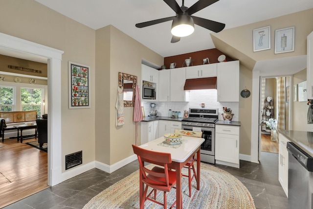 1350 Lancaster Kirkersville Rd NW, Lancaster, OH 43130 - kitchen with stainless steel appliances, premium range hood, white cabinetry, and baseboards