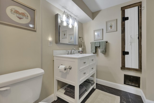 1350 Lancaster Kirkersville Rd NW, Lancaster, OH 43130 - bathroom with baseboards, toilet, marble look tiles, and vanity