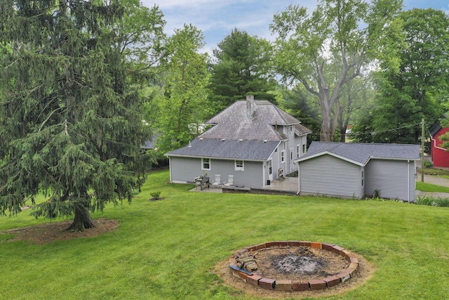 1350 Lancaster Kirkersville Rd NW, Lancaster, OH 43130 - back of house with an outdoor fire pit, a lawn, roof with shingles, and a patio area