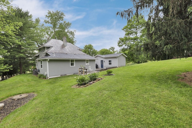1350 Lancaster Kirkersville Rd NW, Lancaster, OH 43130 - back of house with a chimney, a lawn, a patio, and a shingled roof