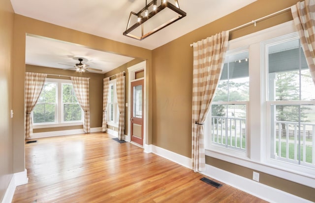 1350 Lancaster Kirkersville Rd NW, Lancaster, OH 43130 - unfurnished room featuring light wood-style floors, baseboards, a chandelier, and a ceiling fan