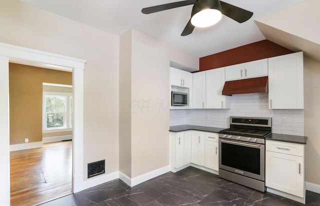 1350 Lancaster Kirkersville Rd NW, Lancaster, OH 43130 - kitchen featuring stainless steel appliances, custom range hood, dark countertops, baseboards, and tasteful backsplash