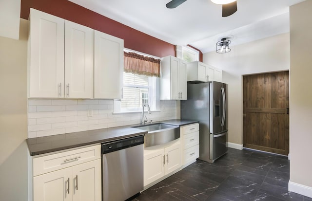 1350 Lancaster Kirkersville Rd NW, Lancaster, OH 43130 - kitchen with appliances with stainless steel finishes, a sink, dark marble finish floors, dark countertops, and decorative backsplash