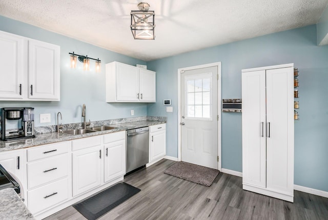 3097 Lee Ellen Pl, Columbus, OH 43207 - kitchen with dishwasher, a sink, dark wood-style floors, white cabinetry, and a textured ceiling